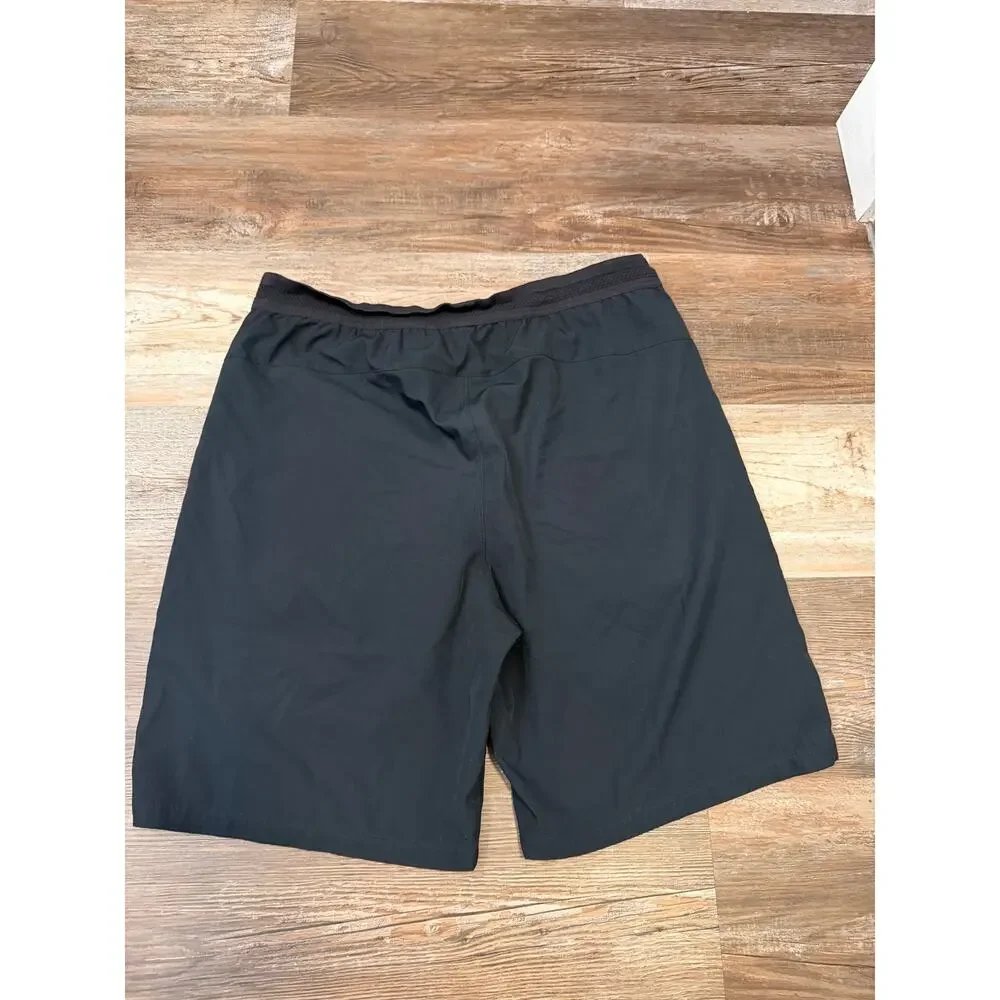 Fabletics Fundamental shorts mens size 34/M in black lined 9in inseam EUC